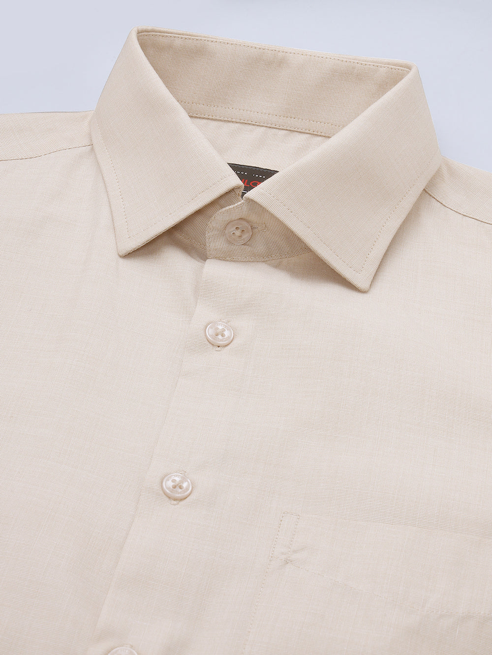 Beige shirt with collar and buttons on a light blue background