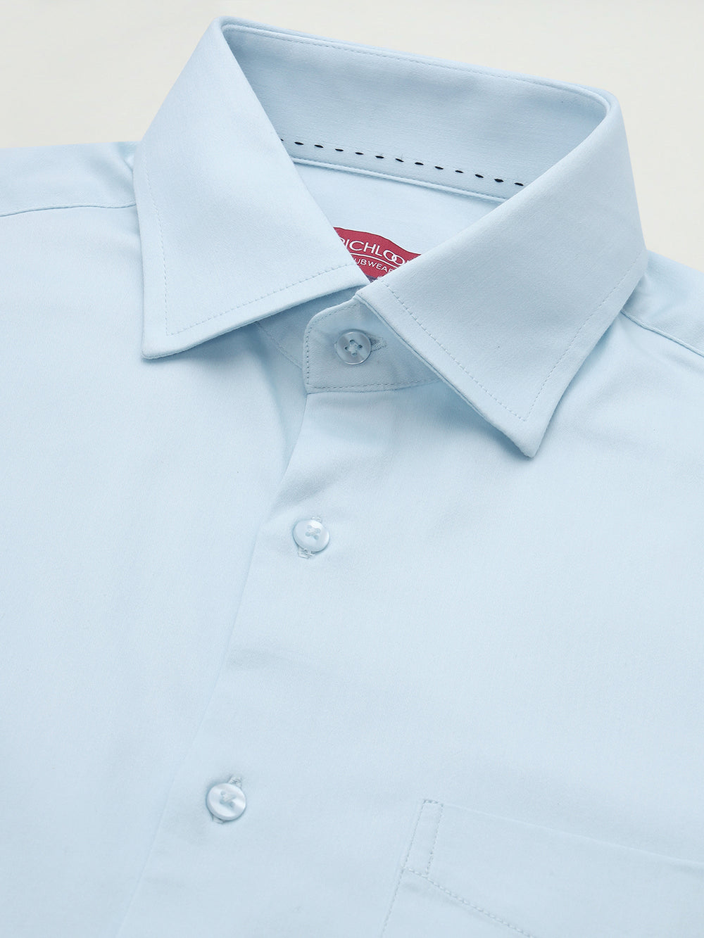 Light blue dress shirt with collar and buttons on a light background