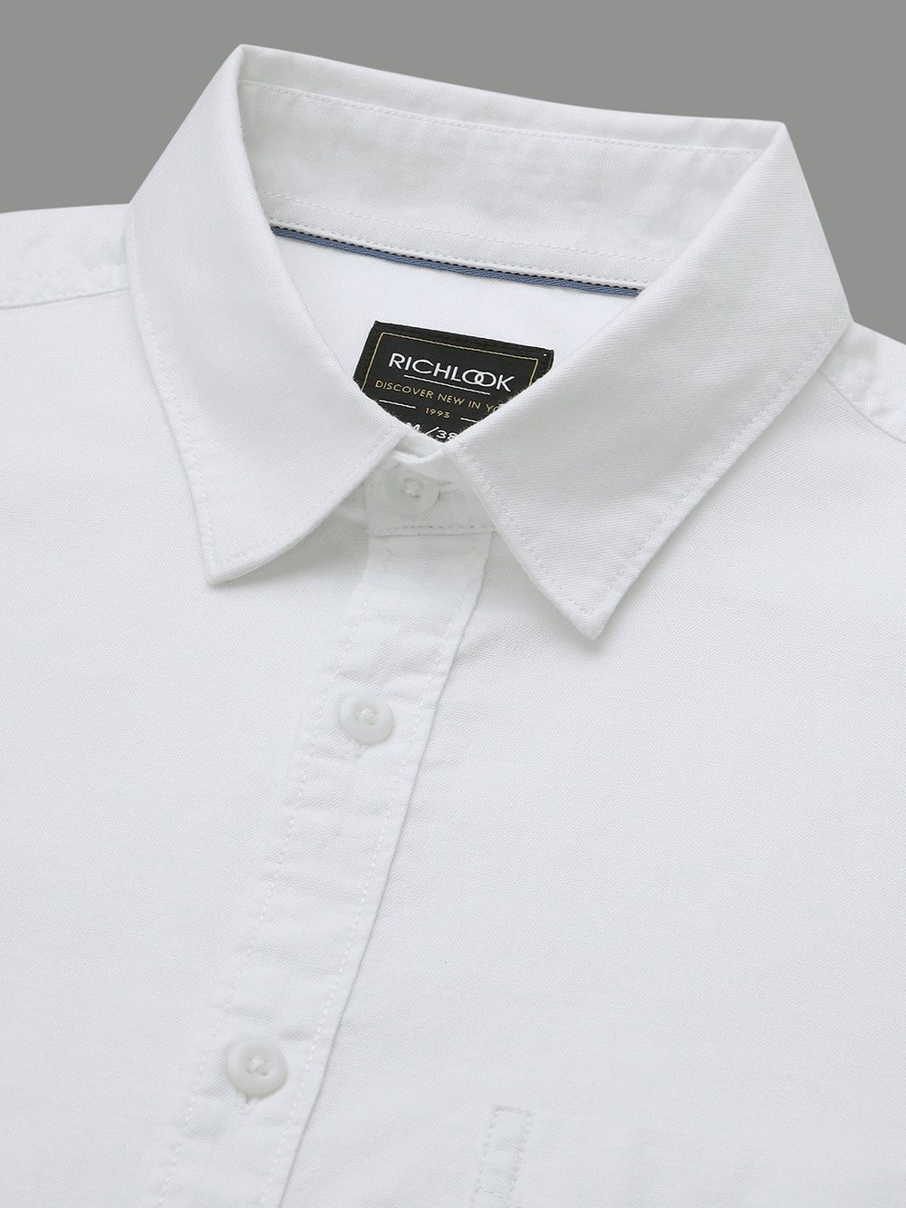 White shirt with a collar and Rich Look label on a gray background