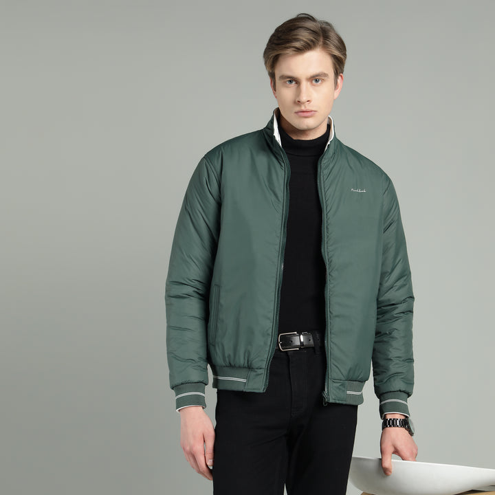 Man wearing a green jacket on a gray background