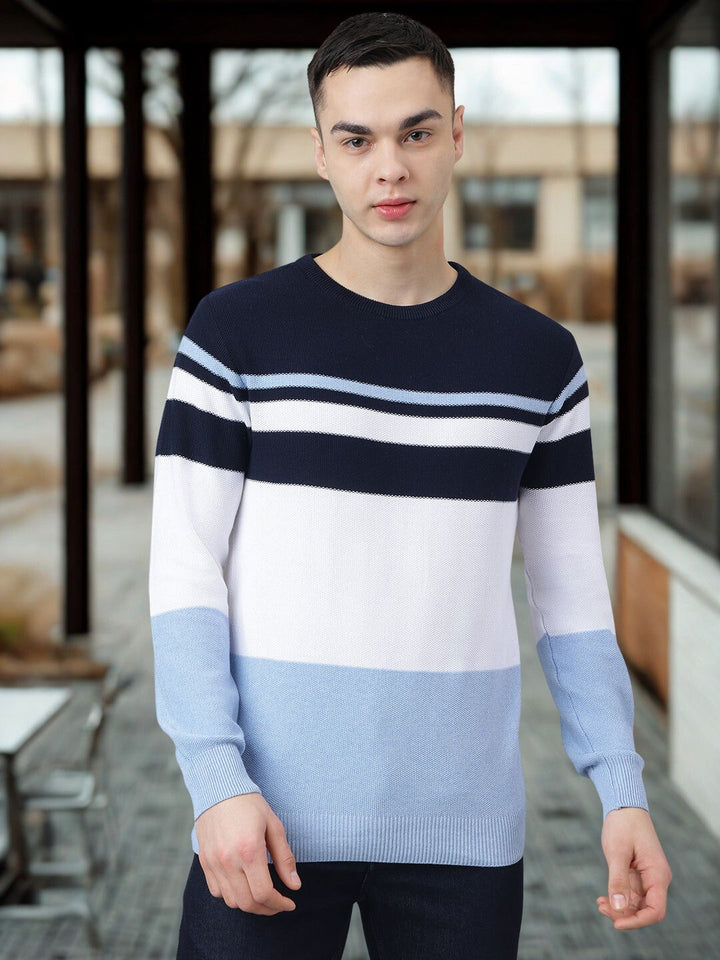 Man wearing a striped sweater standing outdoors